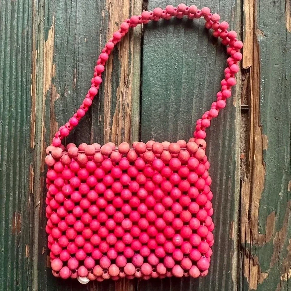 Pink and red beaded‎ bag with heart charm